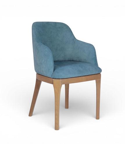 Product view of the Vaya Home Verve dining chair in blue upholstery with curved arms and tapered wood legs.