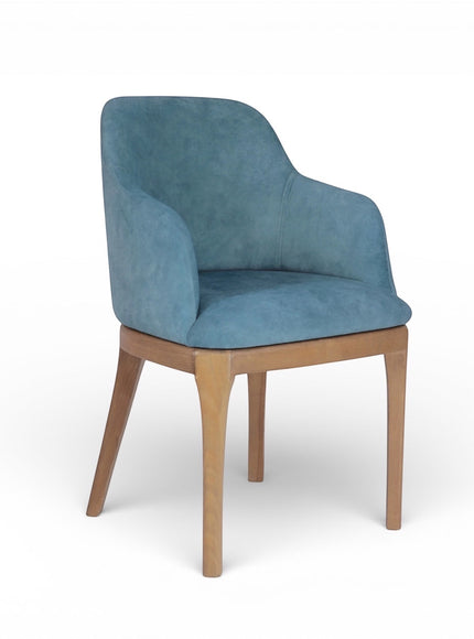 Product view of the Vaya Home Verve dining chair in blue upholstery with curved arms and tapered wood legs.