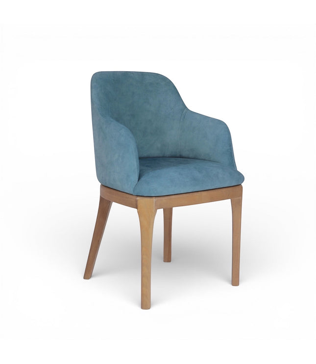 Product view of the Vaya Home Verve dining chair in blue upholstery with curved arms and tapered wood legs.