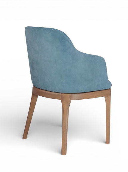 Rear angled view of the Vaya Home Verve dining chair featuring blue upholstery and tapered wood legs.