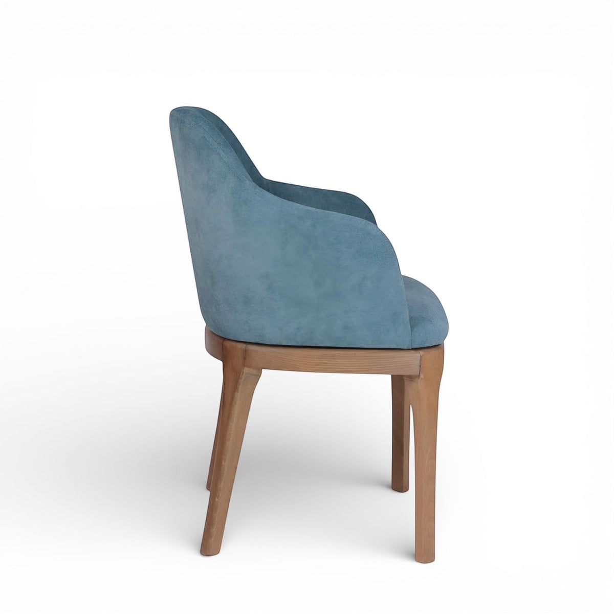 Side view of the Vaya Home Verve dining chair with blue upholstery, curved arms, and tapered wood legs.