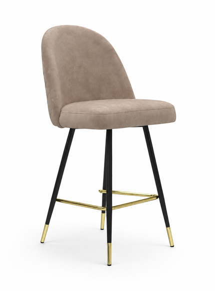 A modern bar stool with a rounded, upholstered seat and backrest in a taupe-beige fabric, supported by slim black metal legs accented with gold hardware and gold-colored foot caps, set against a plain white background.
